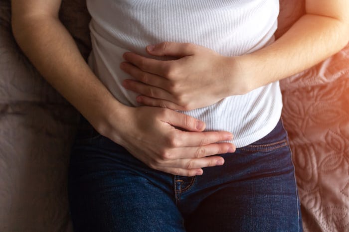 woman holding abdomen