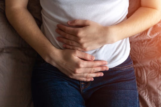 woman holding abdomen