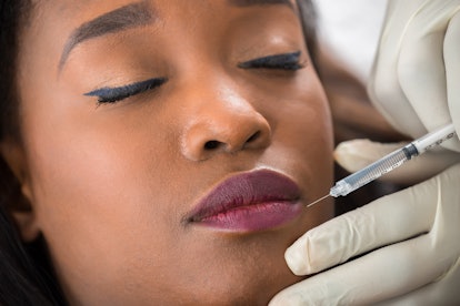 Girl getting a lip filler procedure