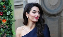 Amal Clooney with a side-part hairstyle in a blue jumpsuit
