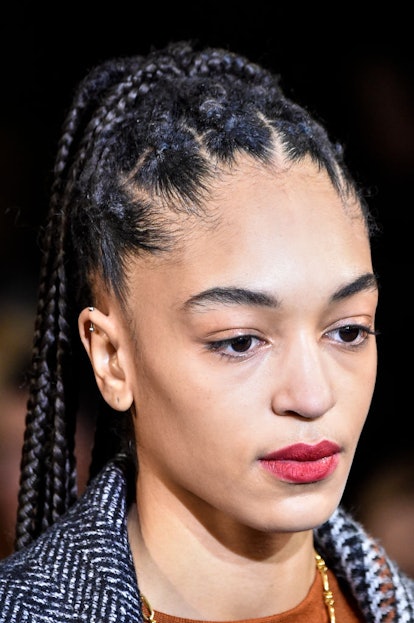 A model with braided hair with lipstick in the Blurred Edge Lip style