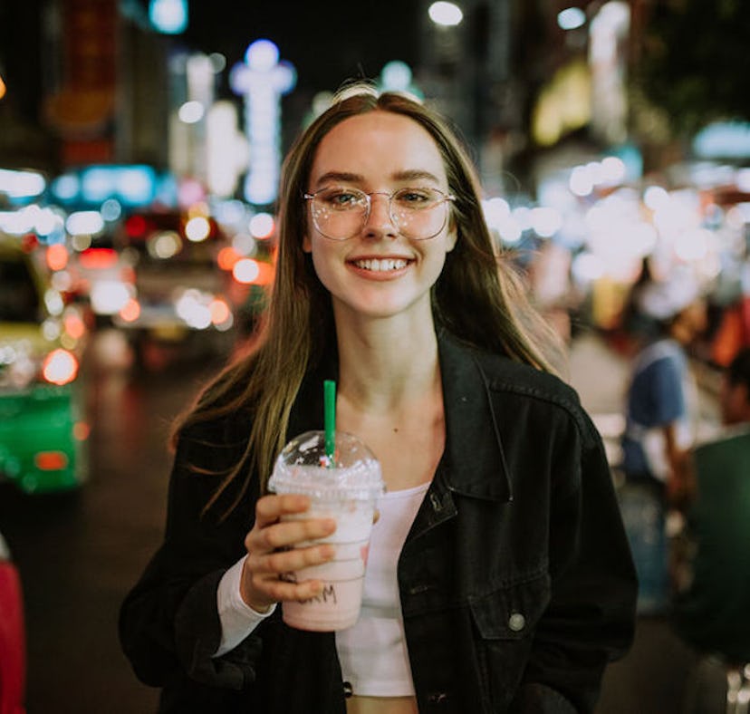 Woman smiling holding a Starbucks drinks who neesd a caption for Instagram.