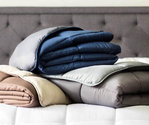 Three sets of bed sheets in grey, beige and blue