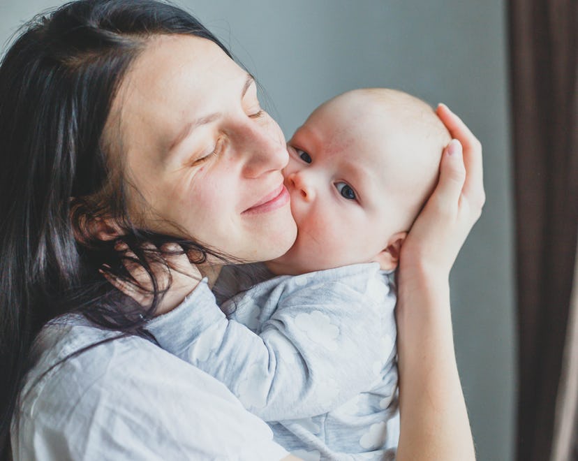 why does my baby try to eat my face? a photo of a mom and baby