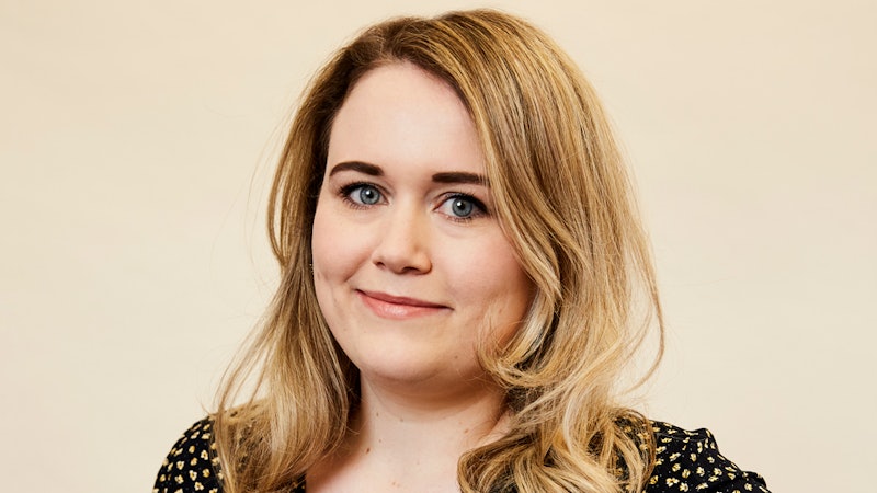 Bustle's editor Charlotte Owen in a black blouse with white dots