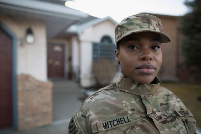 A woman in military uniform posing for a photo