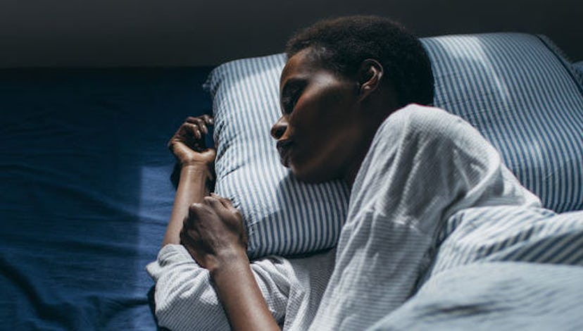 A young woman with a short black hair sleeping on a pillow