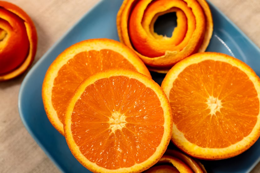 Slices of orange served on a grey plate