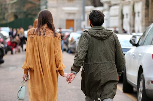 A couple walking on a date with held hands during divorce