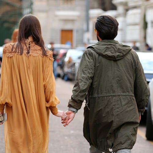 A couple walking on a date with held hands during divorce