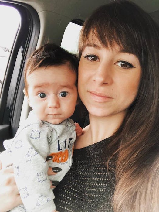 Danielle Campoamor holding her baby while sitting in a car.