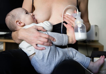 A new mother breastfeeding her baby while at the same time pumping the milk in the bottle as well