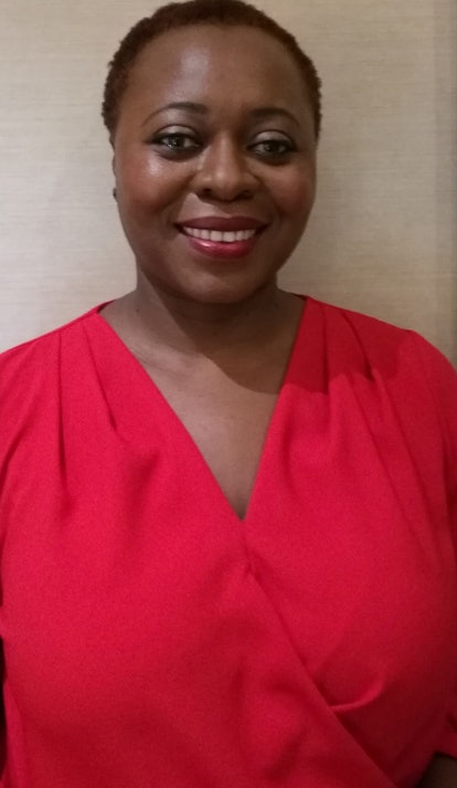 Dr. Olivette Otele smiling in a red blouse