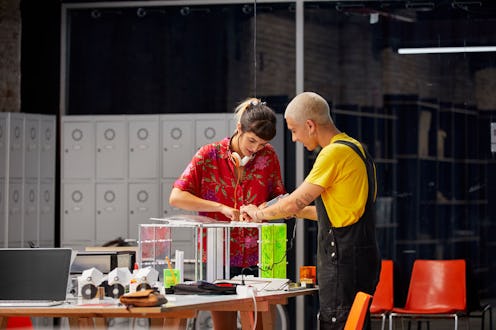  Two British women crafting with a hot glue gun. 