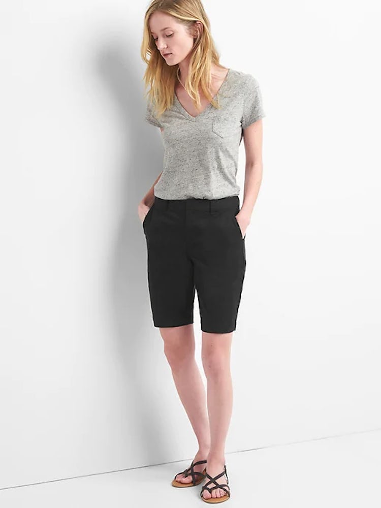 A model in a grey tee and black bermuda shorts