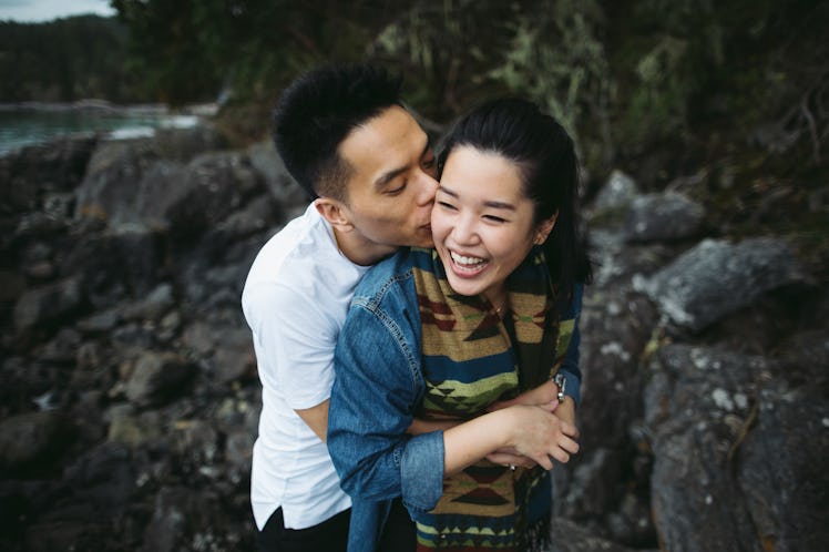 A young couple hugging, as they're helping each other out while coping with stress