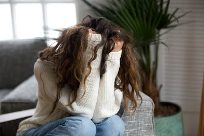 A stressed-out woman runs her hands through her hair. Stress and toxic stress are actually two wholl...