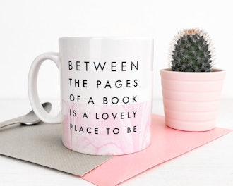 "Between The Pages Of A Book Is A Lovely Place To Be" Mug