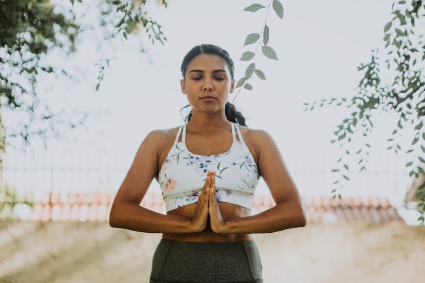 A woman embracing the power of positive thinking by meditating