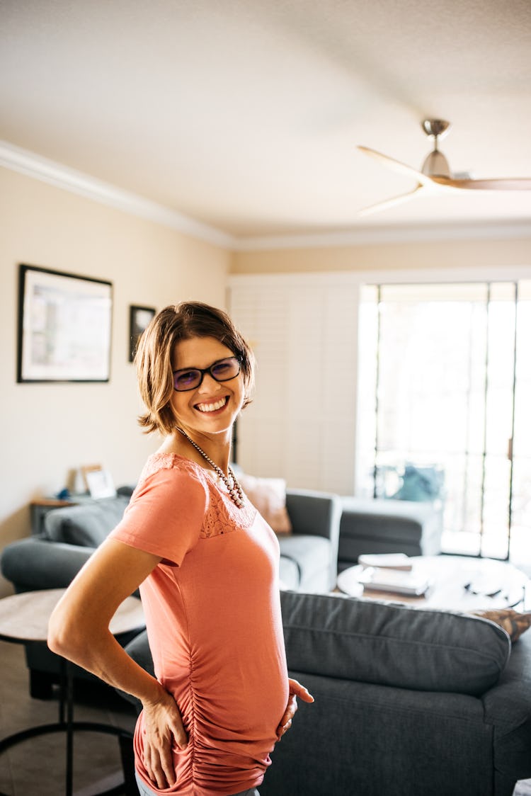 Pregnant woman with an eating disorder posing and smiling toward the camera