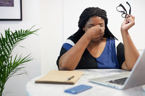 A stressed out person rubs the bridge of her nose with her glasses off. Experts reveal ways stress c...