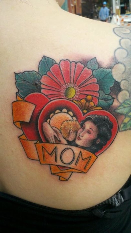 Mom tattoo on the back of a woman 