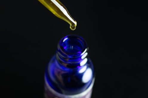 CBD oil blue bottle and golden dropper