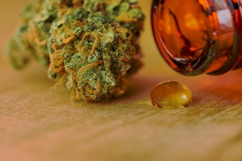 A weed head and CBD oil bottle