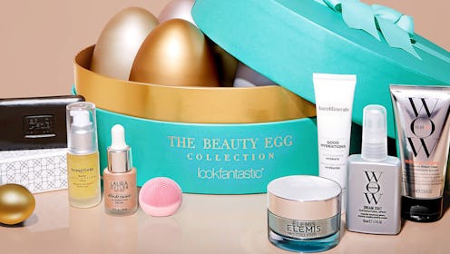 The beauty egg collection by lookfantastic in a round teal box with golden eggs placed inside and be...