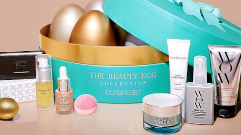 The beauty egg collection by lookfantastic in a round teal box with golden eggs placed inside and be...