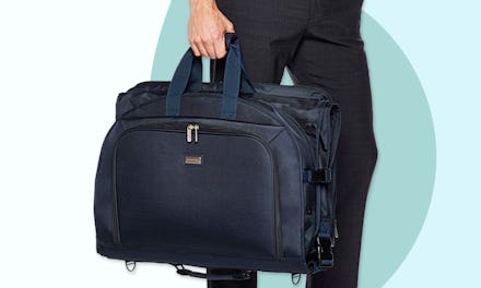 a man holding a travel garment bags in order to keep his clothing neat and wrinkle-free