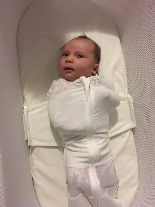 A baby strapped safely in the SNOO Smart Sleeper bassinet 
