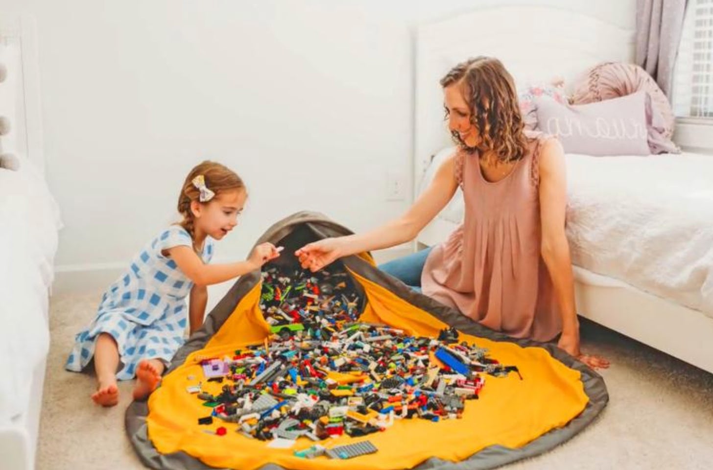 This SlideAway Basket & Play Mat Is Going To Change Toy Cleanup Forever