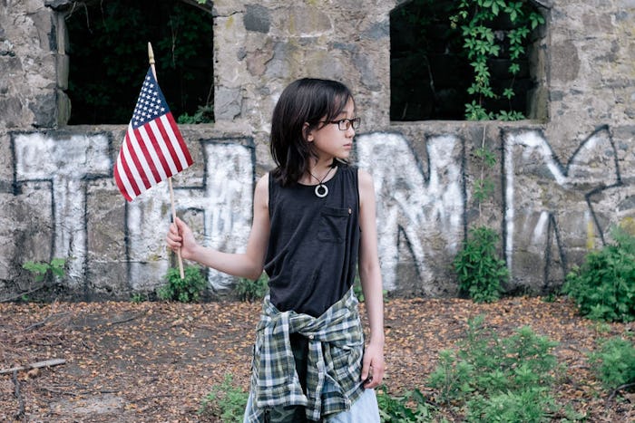 a young girl holding an american flag