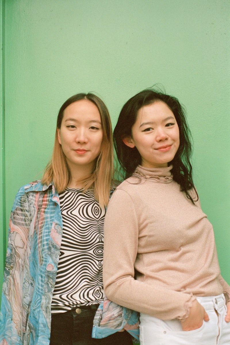 Vicki Ho and Kathleen Tso, the founders of Banana magazine posing in front of a green background