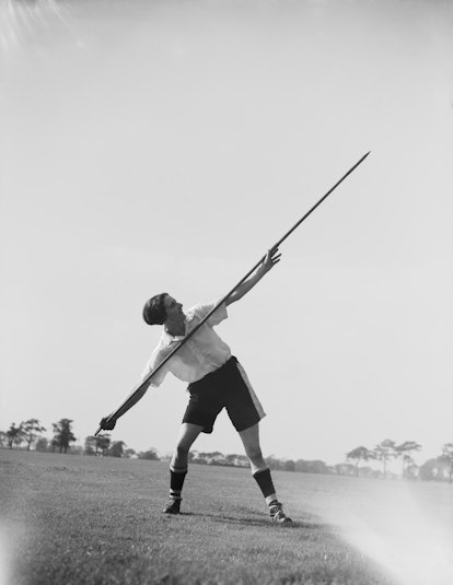 A black and white vintage photo of Lily Parr throwing javelin. 