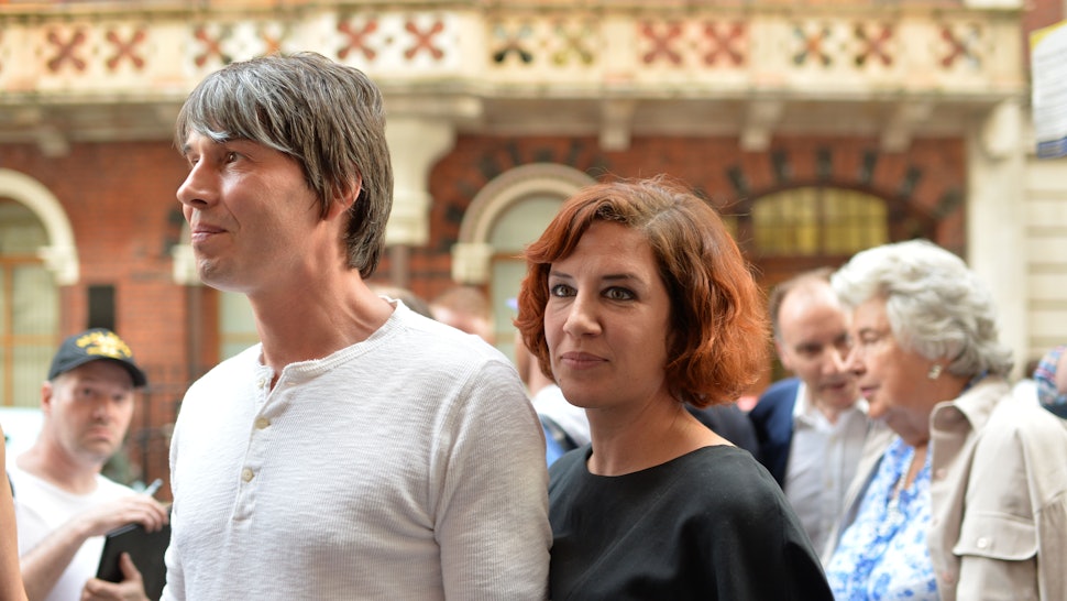 How Did Brian Cox & Gia Milinovich Meet? It's As Cute & Geeky As You'd