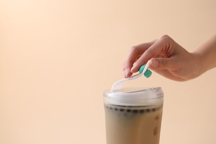 A woman closing the reusable bubble tea cup that was designed to eliminate single-use plastic
