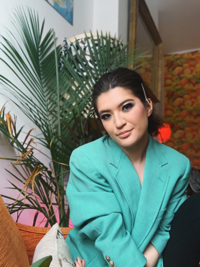 Writer Arabelle Sicardi posing for a photo in a turquoise blazer 