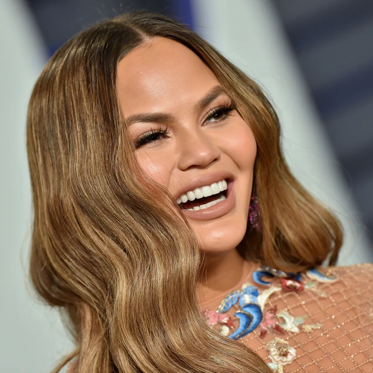 chrissy teigen orange dress How Chrissy Teigen Scored a 4-Chair Turn on The Voice