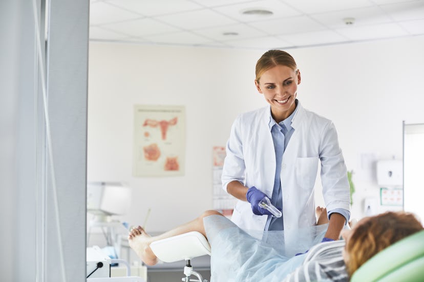 A doctor putting an IUD in the body of a woman