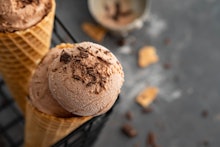 Two CBD-infused chocolate ice-cream cones, with chocolate sprinkles on top