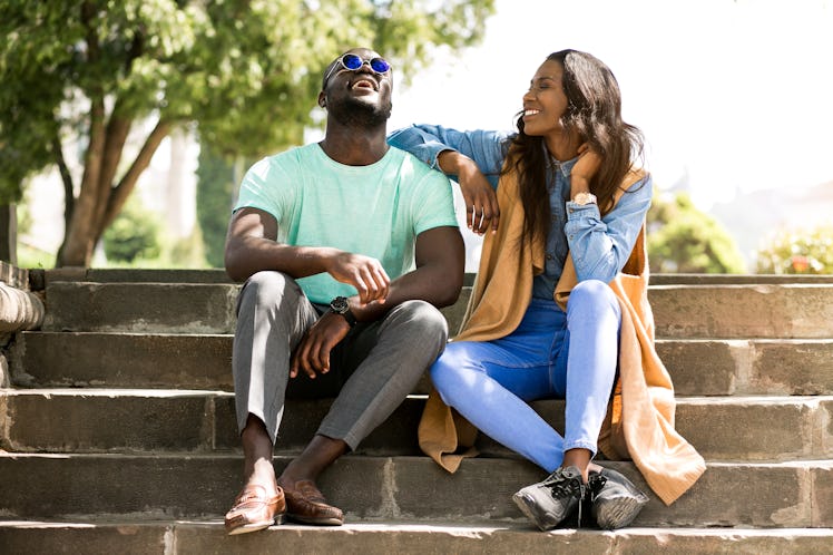 Couple laughing after connecting over Hinge's "Leave a comment if" prompt.