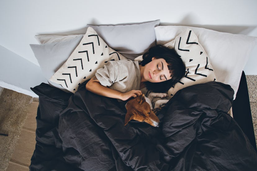 woman sleeping with pet