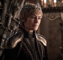 A closeup of Cersei in Game of Thrones with short hair and a crown