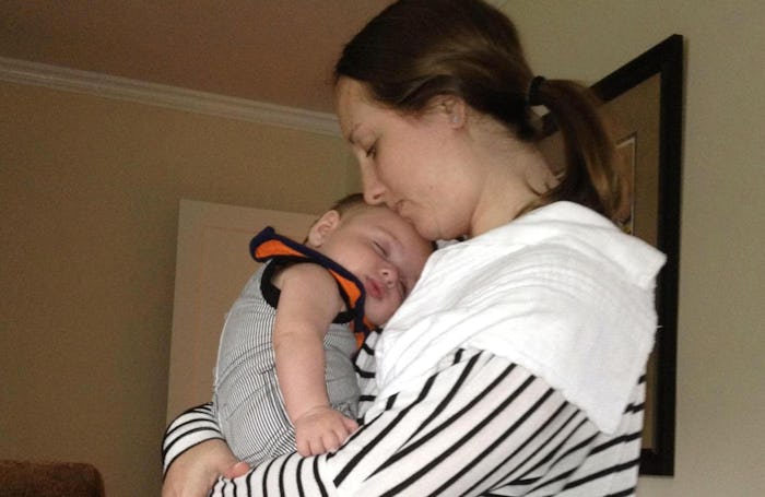 A mom with postpartum depression holding her baby on Mothers' Day
