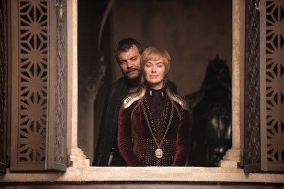 Euron standing behind Cersei as she looks out the window 