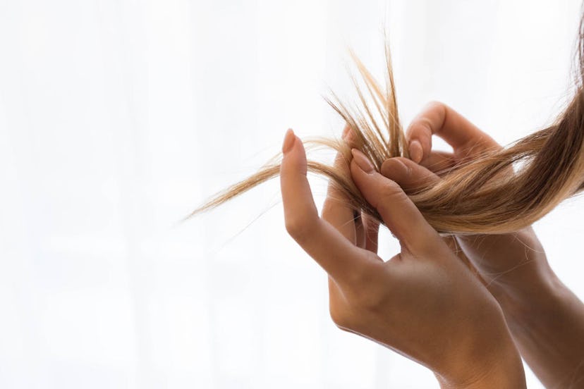 A woman diagnosed with psoriasis observing her hair