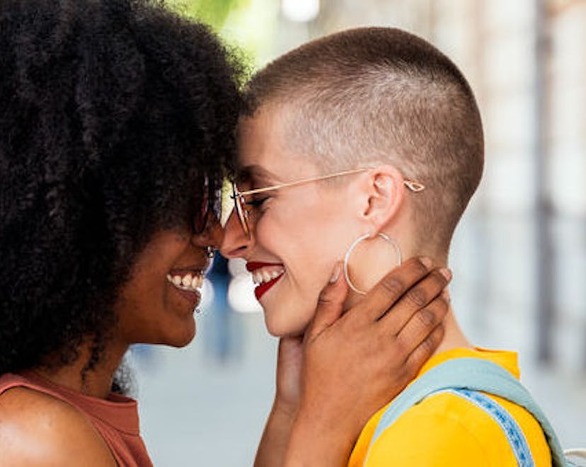 A Fabulous LGBTQ+ couple smiling while looking at each other
