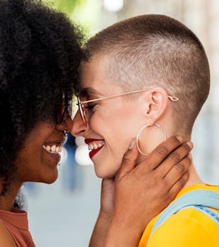 A Fabulous LGBTQ+ couple smiling while looking at each other